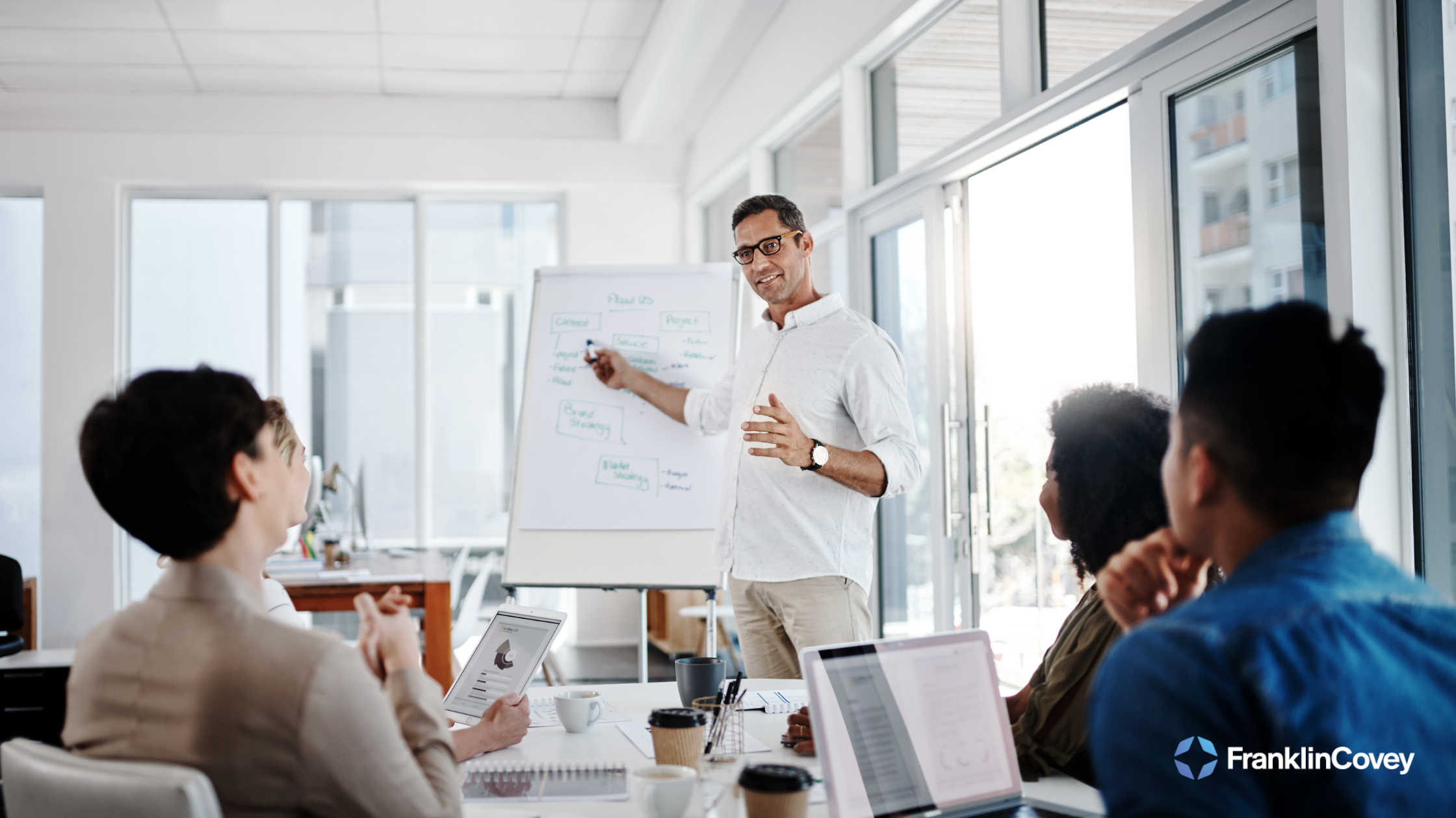 A business leader presenting strategies in an executive training workshop.